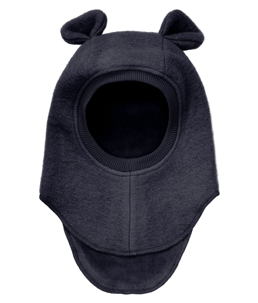 Supersøt og varm balacalva med små ører i tovet ull (80% ull og 20% polyester) fra HUTTEliHUT. Foret er laget av myk bomullsvelour som gjør den ekstra varm og vindtett på kalde dager. Ribbekanten rundt ansiktet er i bomull som gjør at den ikke klør. Vaskes fint på 30 grader ullprogram med vaskemiddel for ull/silke. Tørkes flatt.