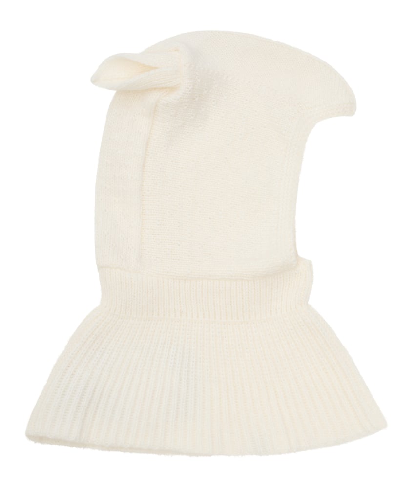 Fin og myk HUTTEliHUT-balaclava. Finstrikket med små ører på begge sider. Luen har en strikket ribbekant rundt åpningen for å sikre god passform. Laget av 70% merinoull og 30% kashmir. Kan vaskes på 30 grader ullprogram med vaskemiddel for ull/silke. Tørkes flatt. Sertifisert med Standard 100 fra OEKO-TEX®.